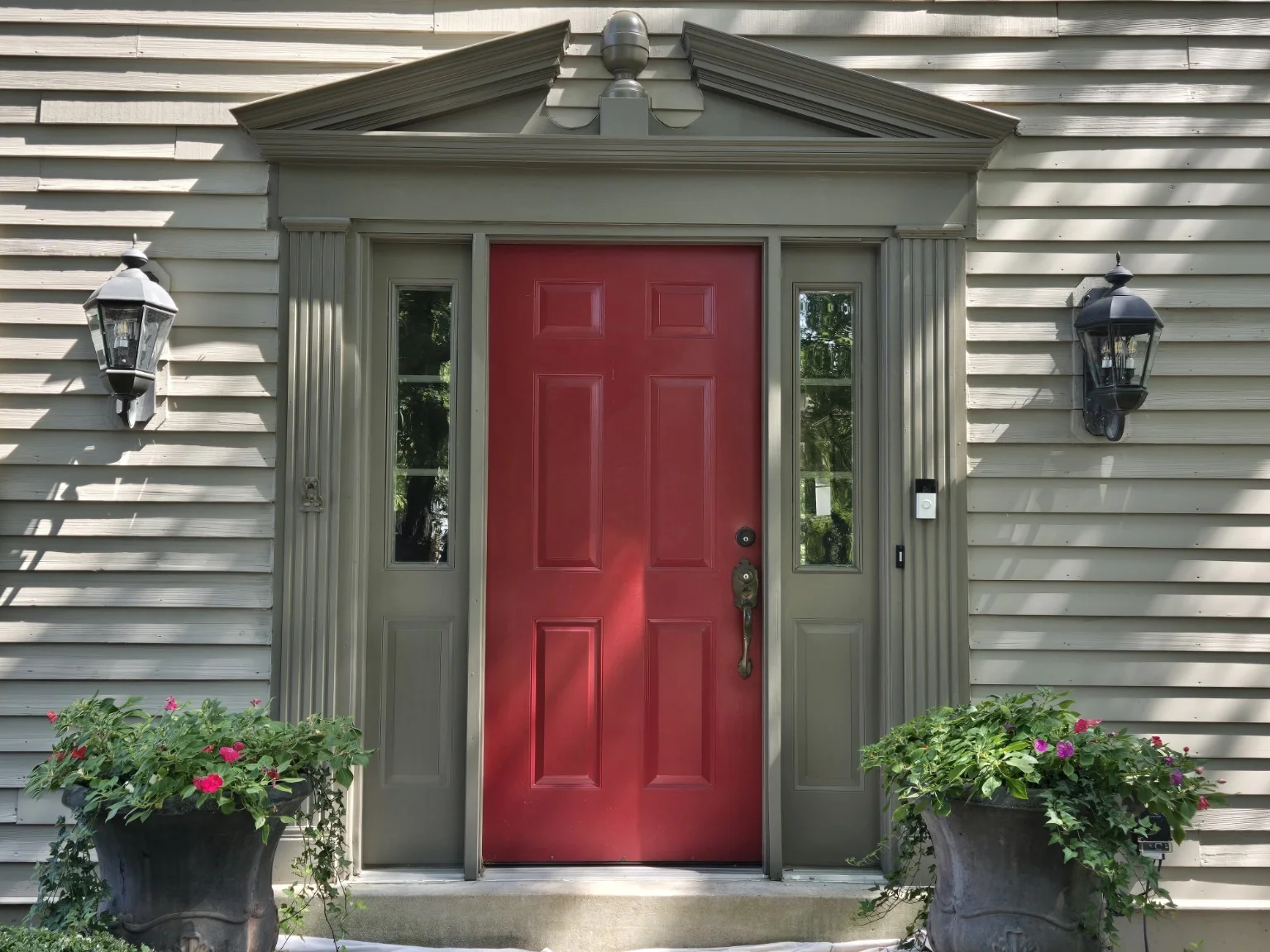 Completed reconstructed architectural pediment installed above the red front door