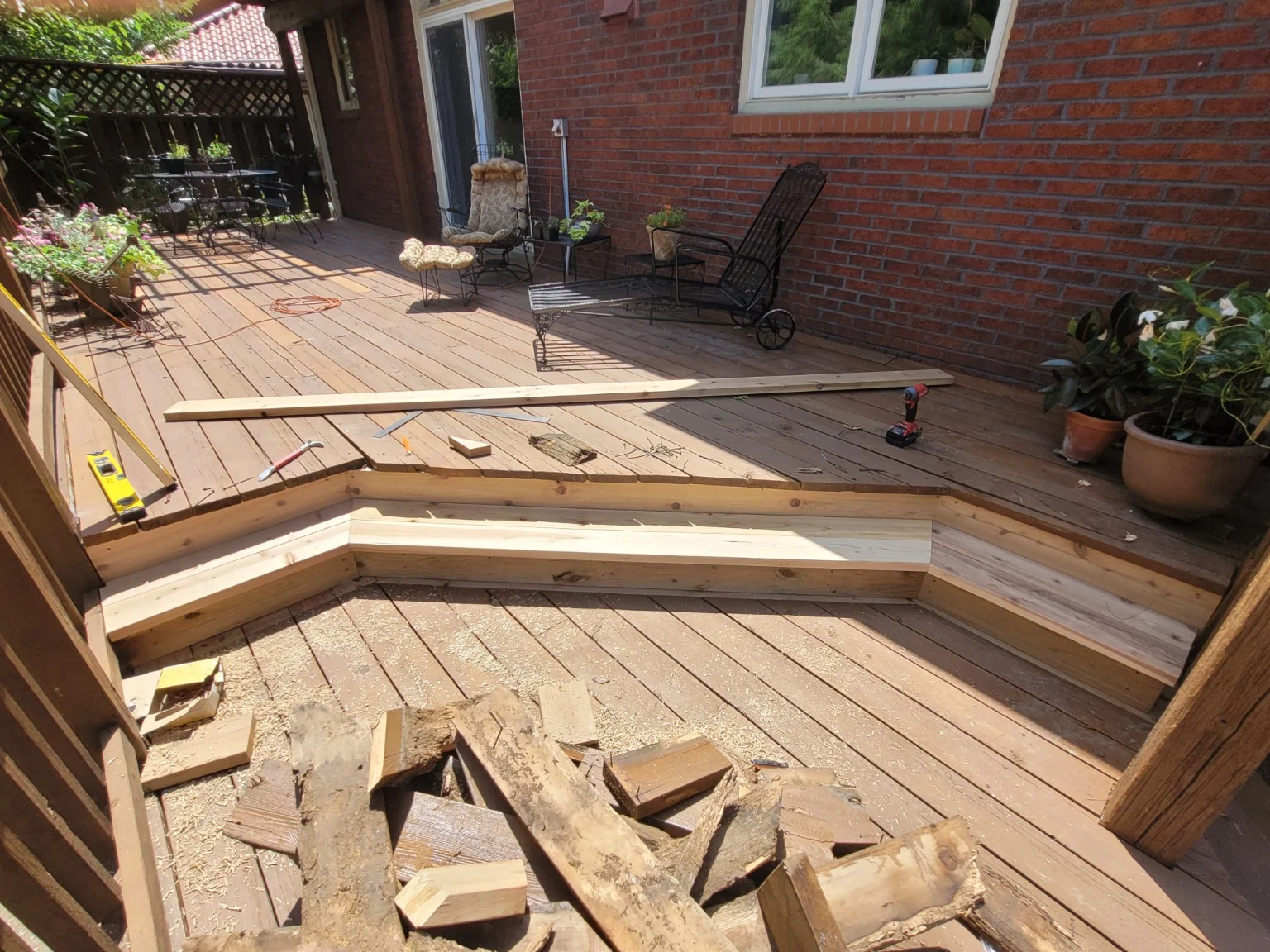 Wraparound deck step rebuilt with new framing and fitted risers